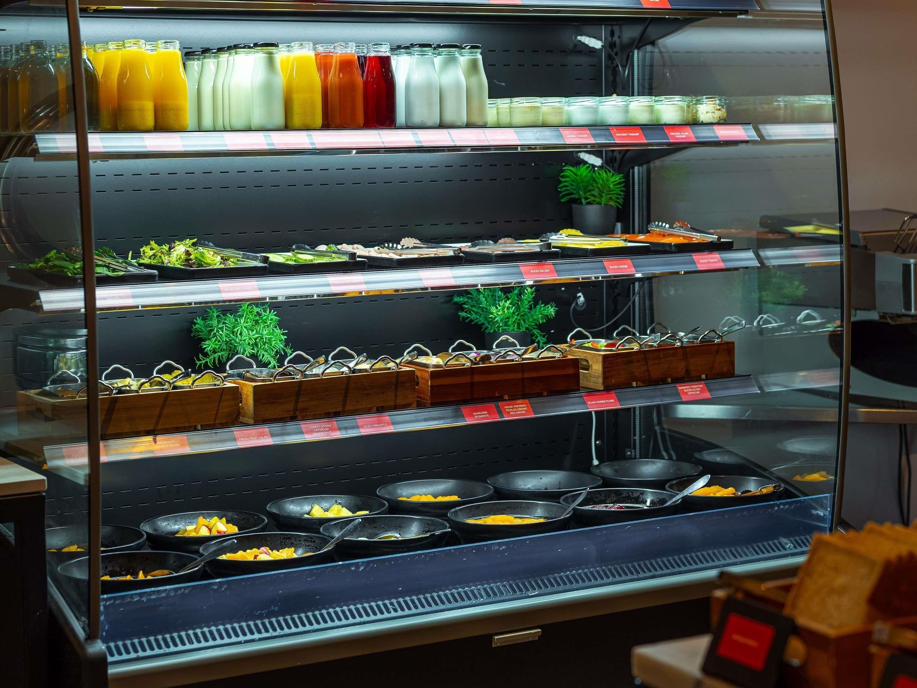 A refrigerated display case with various food items and beverages.