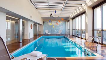 Indoor pool, pool umbrellas, pool loungers