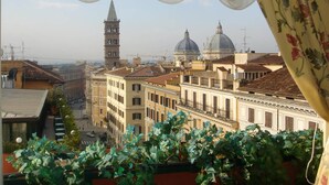 A view of a cityscape with historic buildings, a prominent tower, and domed structures. - Champagne Palace Hotel (Rome)