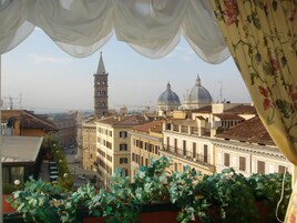 A view of a cityscape with historic buildings, a prominent tower, and domed structures.