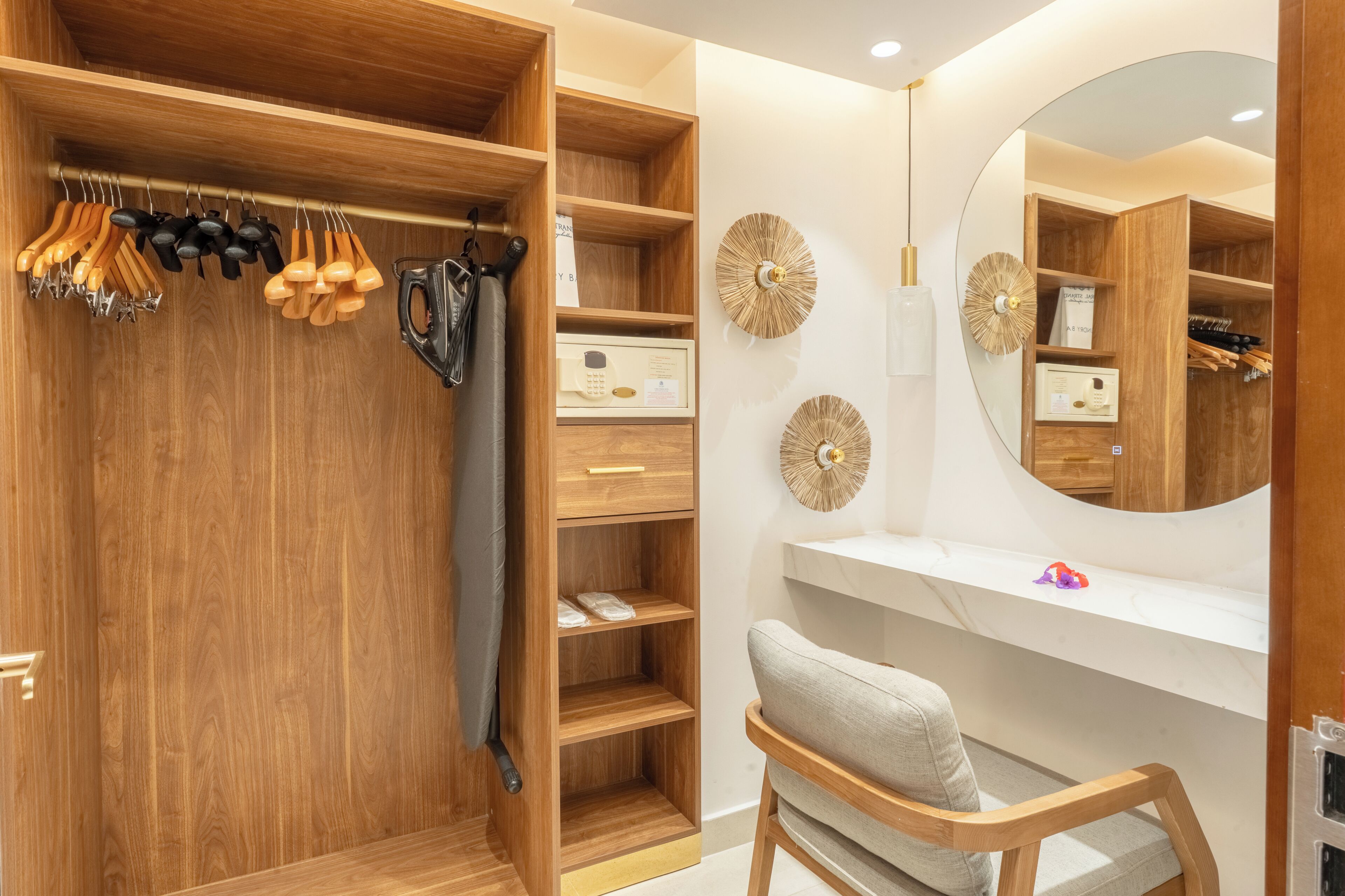 A wooden closet with hanging tools, a mirror, and shelves.