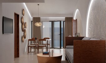 Una sala de estar moderna con un sofá, una mesa de centro y un comedor con sillas.