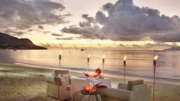 On the beach, white sand, sun loungers, beach towels
