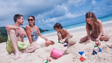 On the beach, white sand, sun loungers, beach towels
