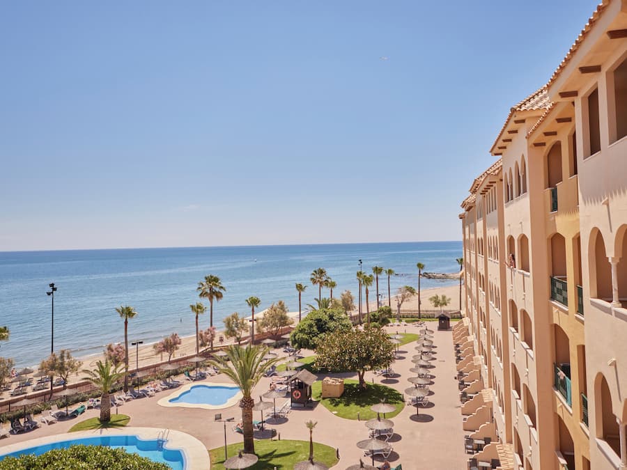 A resort with a pool, beach, and ocean view.
