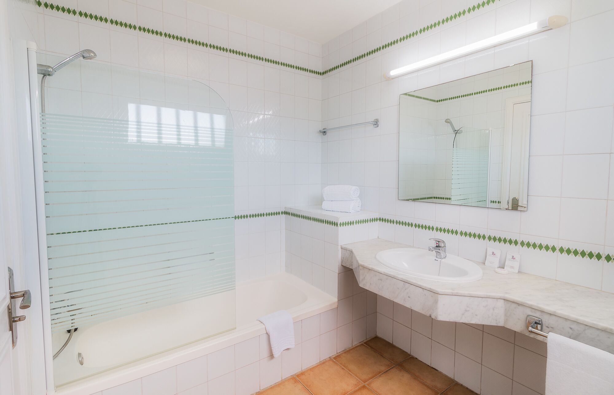 Un baño con bañera, lavamanos y ducha.