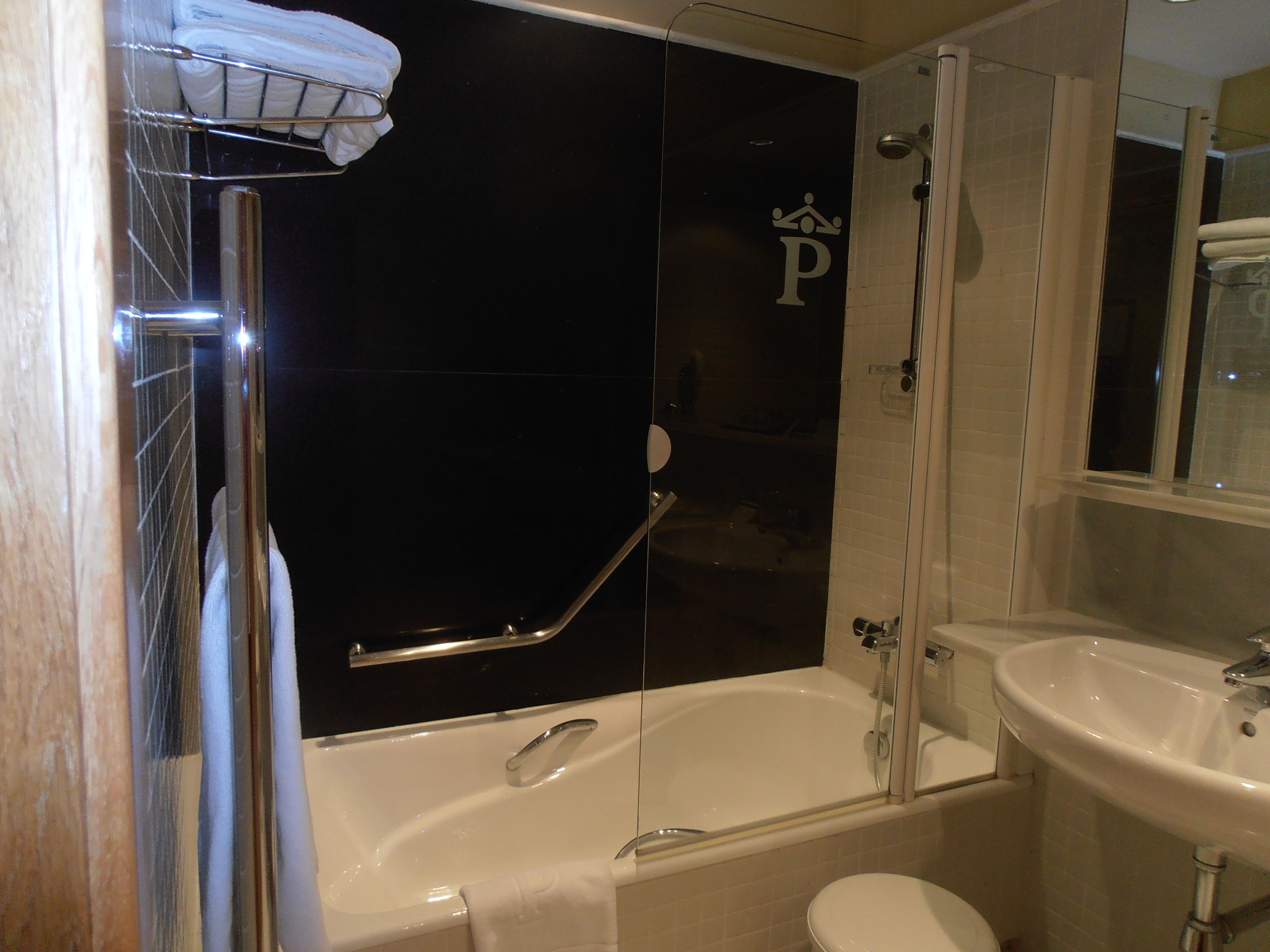 A bathroom with a bathtub, toilet, and sink.