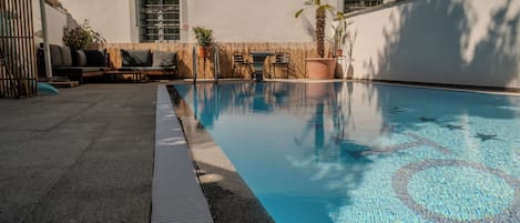 Seasonal outdoor pool, open 10:00 AM to 9:00 PM, sun loungers