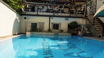 Seasonal outdoor pool, open 10:00 AM to 9:00 PM, pool loungers