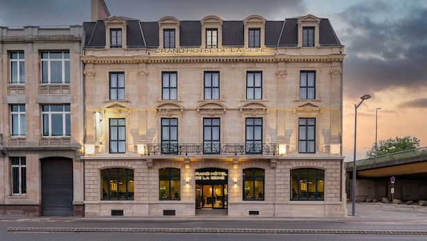 A grand hotel with a classic facade, multiple windows, and a prominent entrance. - Grand Hôtel de la Seine (Rouen)