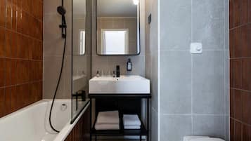 Bathtub, eco-friendly toiletries, hair dryer, towels