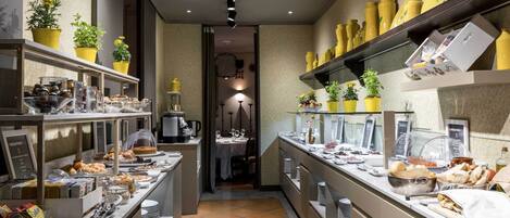 A buffet setup with various food items and a coffee station.