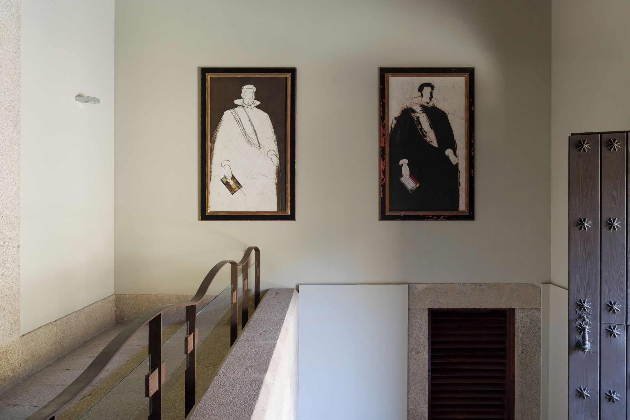 A staircase with a handrail and a wall-mounted light fixture.