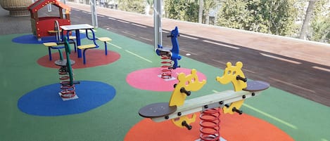 A playground with colorful equipment and a picnic table.