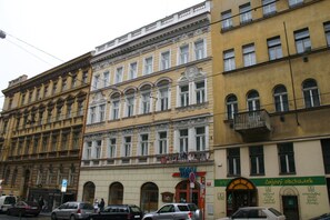 A multi-story building with a storefront labeled "Tosca" and a sign for "Easter Market". - EA Hotel Tosca (Prague)