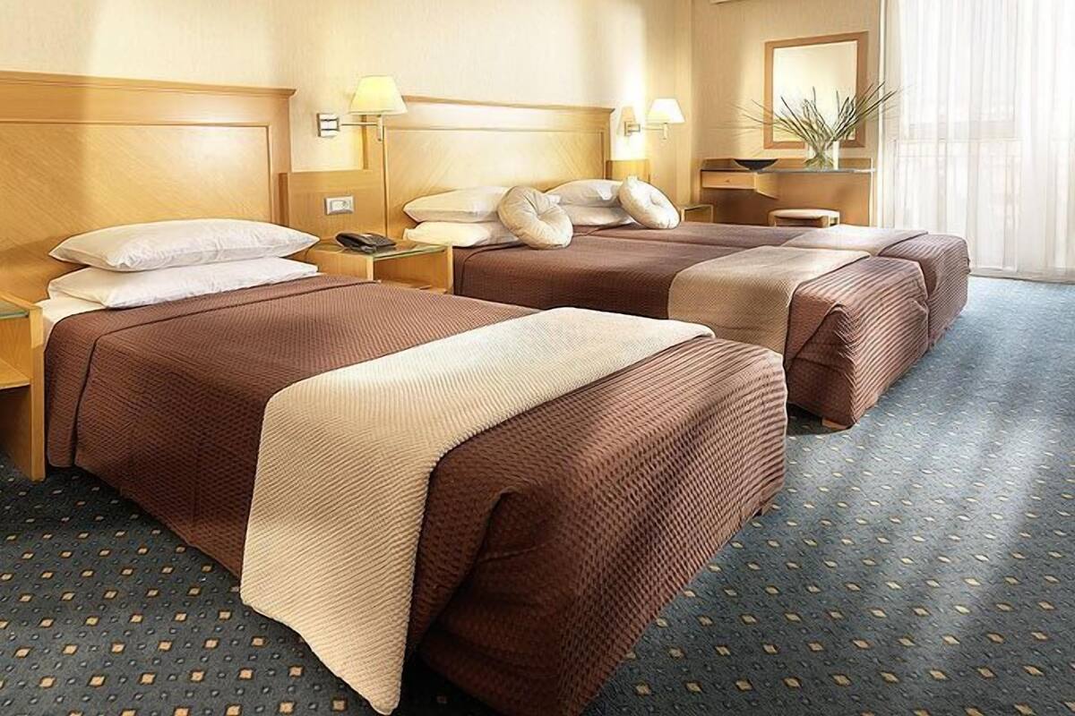 Triple Room | Minibar, in-room safe, blackout drapes, iron/ironing board (on request)