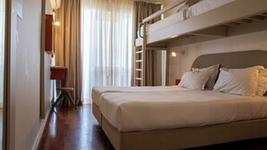 A hotel room with two beds, a ladder, a desk, and a window with curtains. - WOT Lagos Montemar Soul (Lagos)