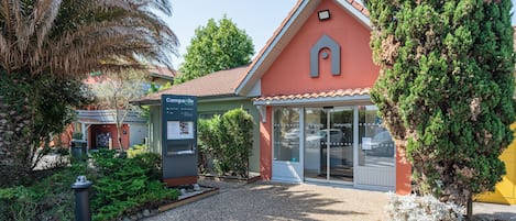 A building with a reception area, a restaurant, and a parking lot.
