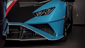 A blue sports car parked indoors with a visible 'TAL' marking on the floor. - Hotel Cristal (Sirmione)