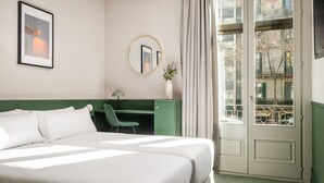 A hotel room with a large bed, a desk, a chair, a mirror, and a view of the outside. - BYPILLOW Mothern (Barcelona)