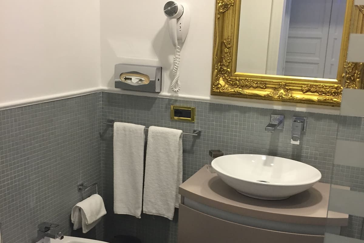 deep-soaking bathtub, rainfall showerhead, designer toiletries