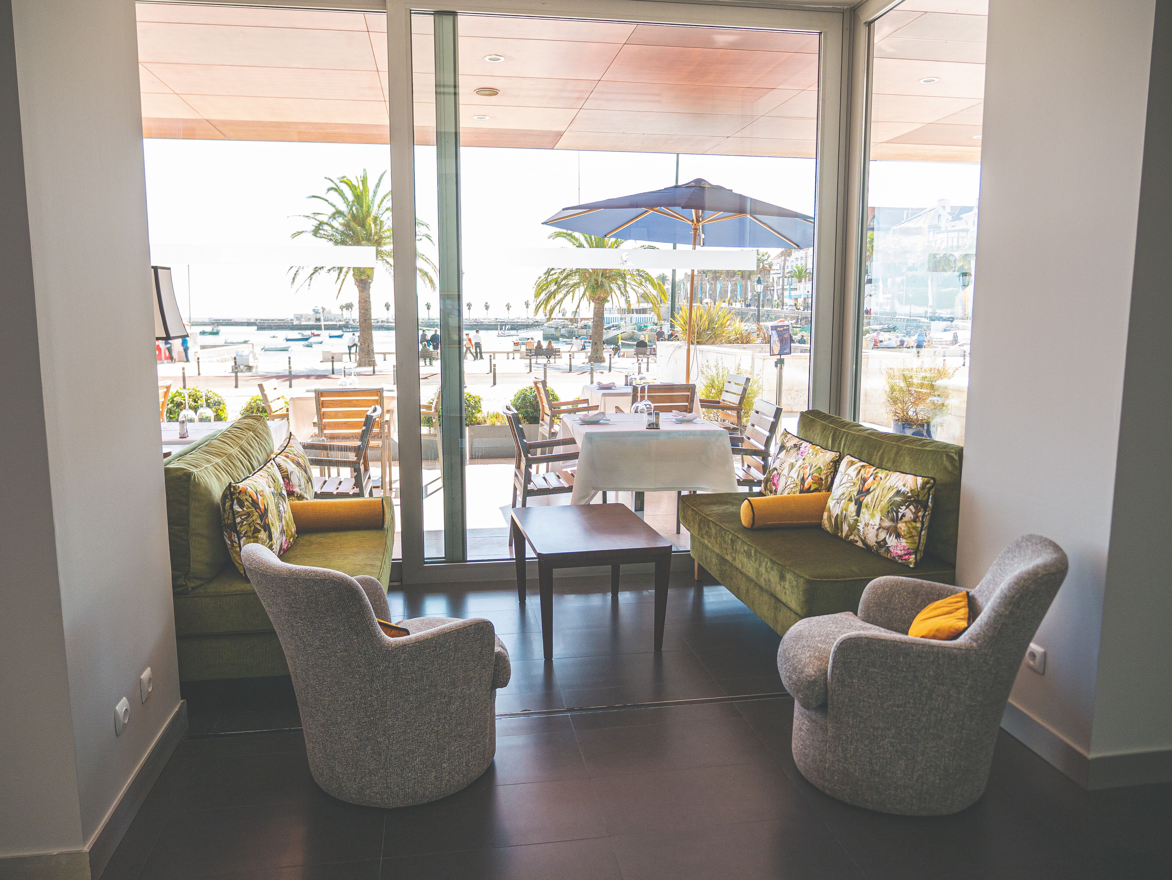 A modern indoor seating area with a view of the marina.