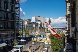 A cityscape with a prominent flag, buildings, and a statue.