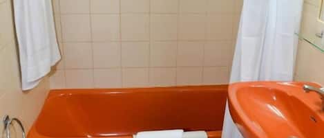 A bathroom with a bathtub, sink, and toilet.