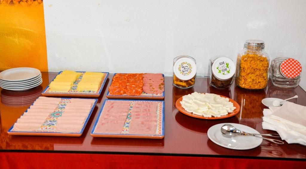 A buffet table with various food items and condiments.