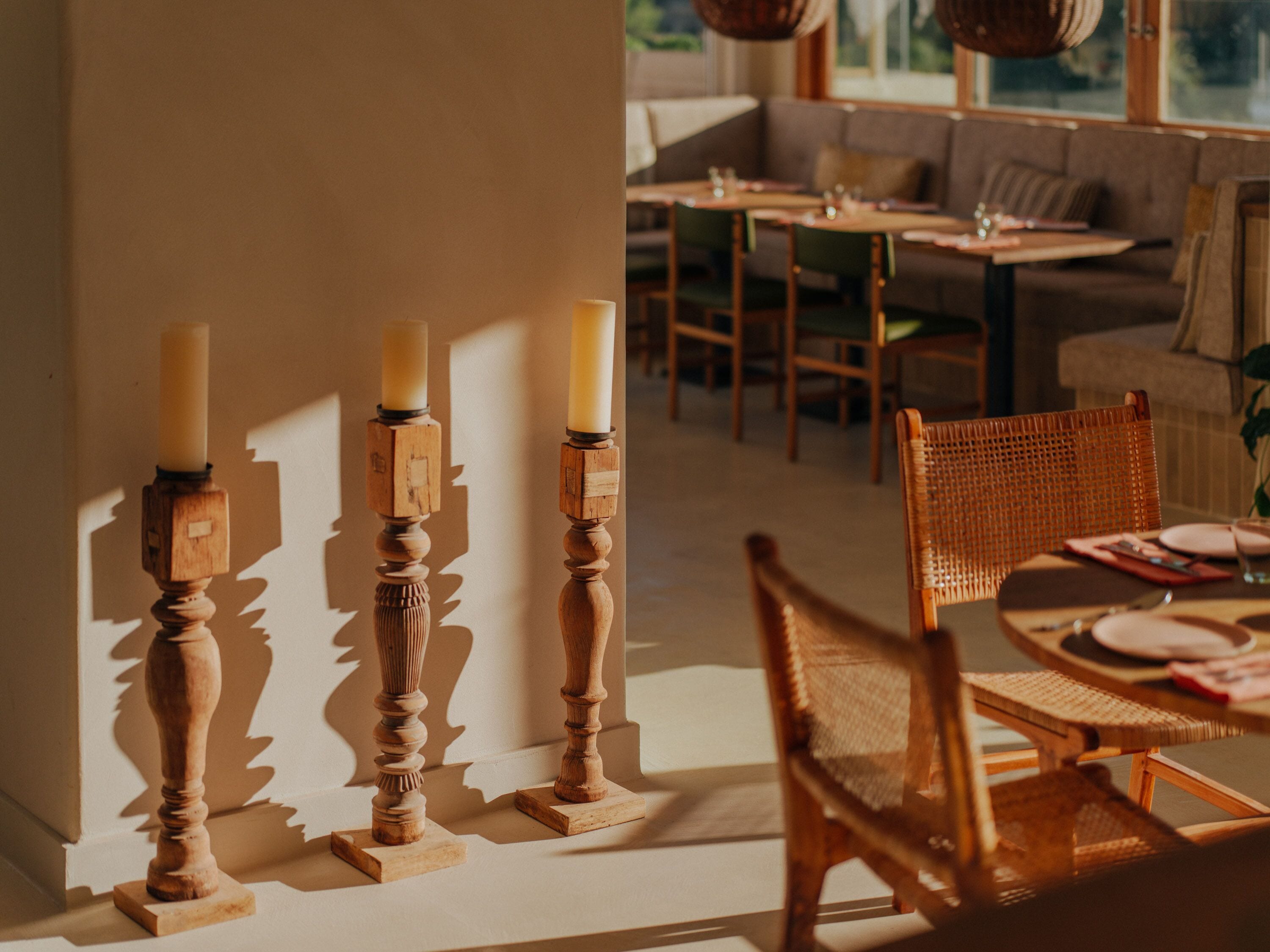 A dining area with wooden furniture and candle holders.