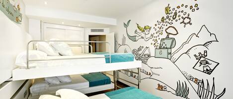 A bunk bed room with a mural of a mermaid and underwater scene.