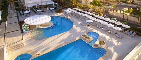 Una piscina techada, 2 piscinas al aire libre, sombrillas