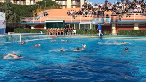 A swimming pool with a spectator area and a building in the background. - Hotel Mediterraneo (Syracuse)