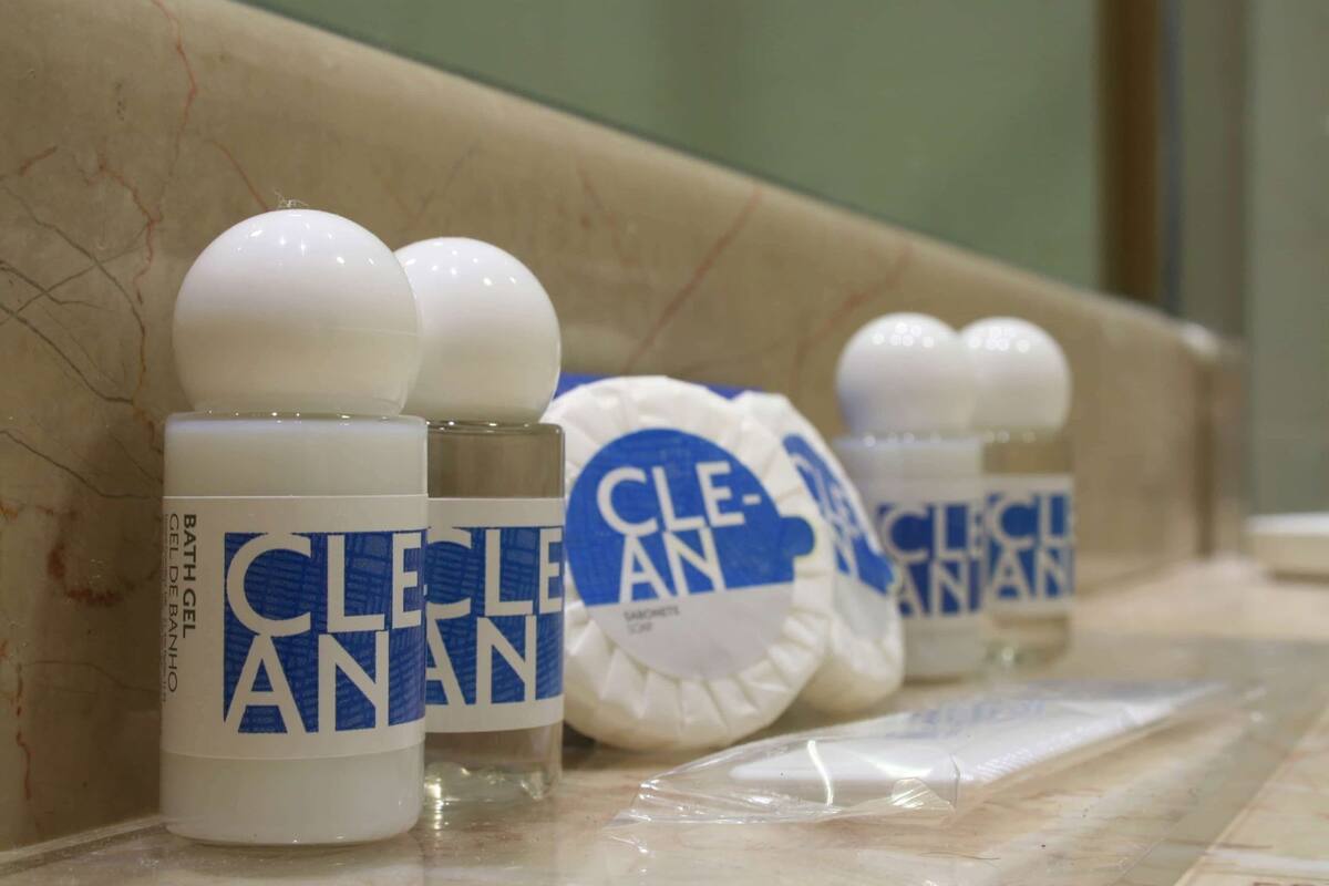 A row of toiletries on a bathroom counter.