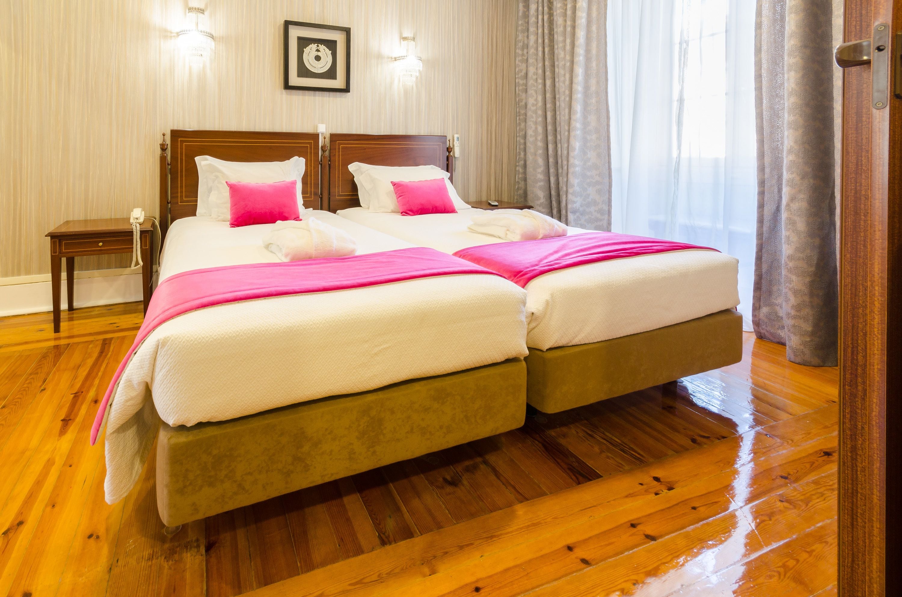 A double bed with two pillows, a bedside table, and a nightstand.