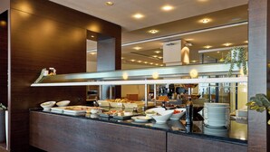 A buffet area with various food items and a coffee station. - Hotel Strudlhof (Vienna)