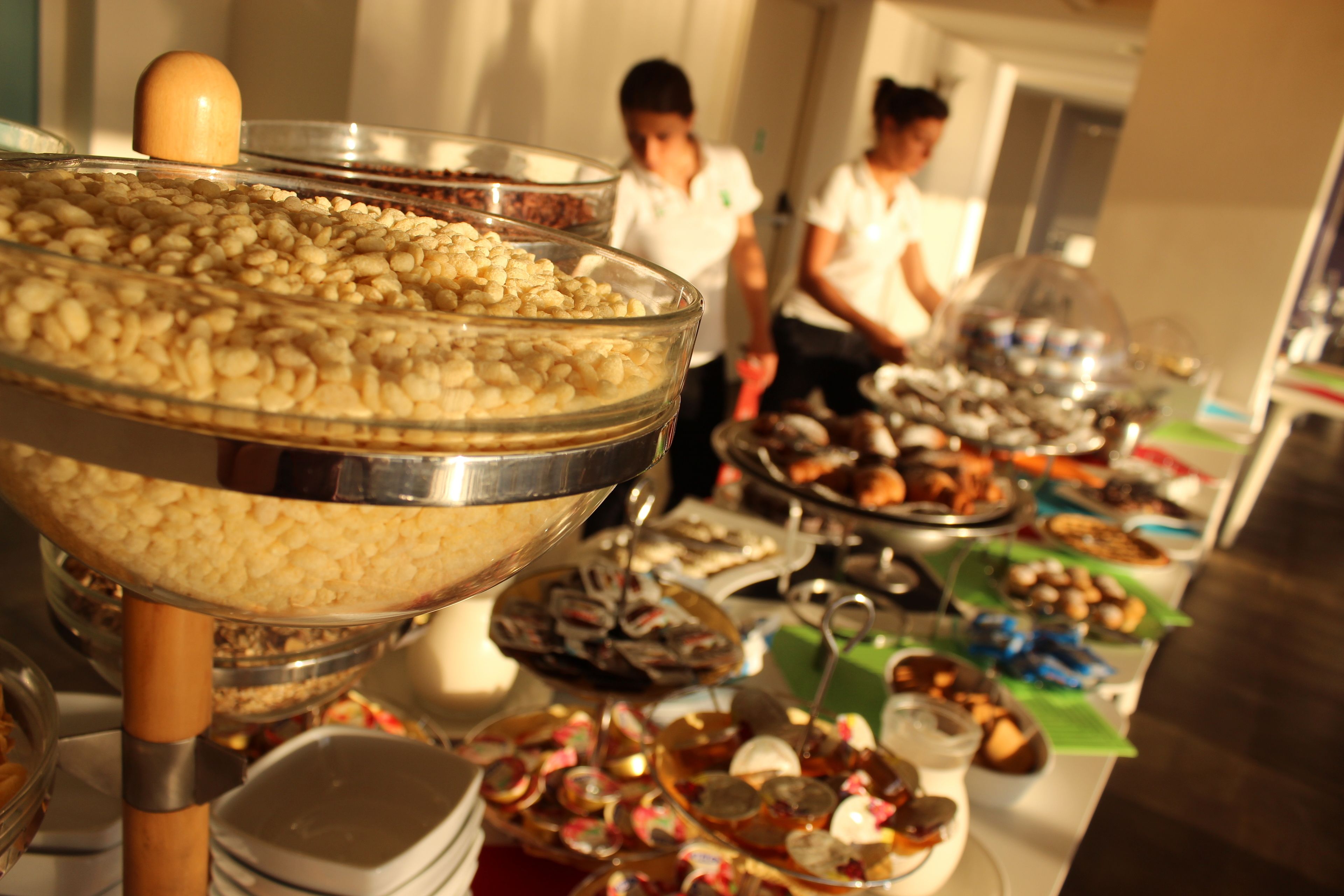 A buffet with various food items and a large bowl of nuts.