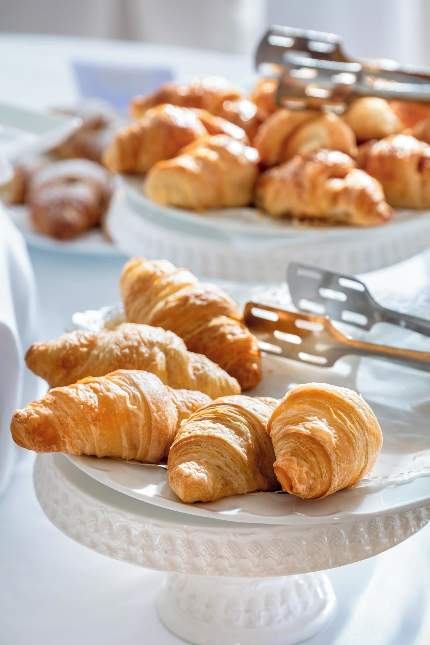 A table with croissants and a spatula.