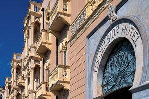 The exterior of the Excelsior Hotel with ornate architectural details and a prominent entrance. - Excelsior Palace Hotel (Taormina)