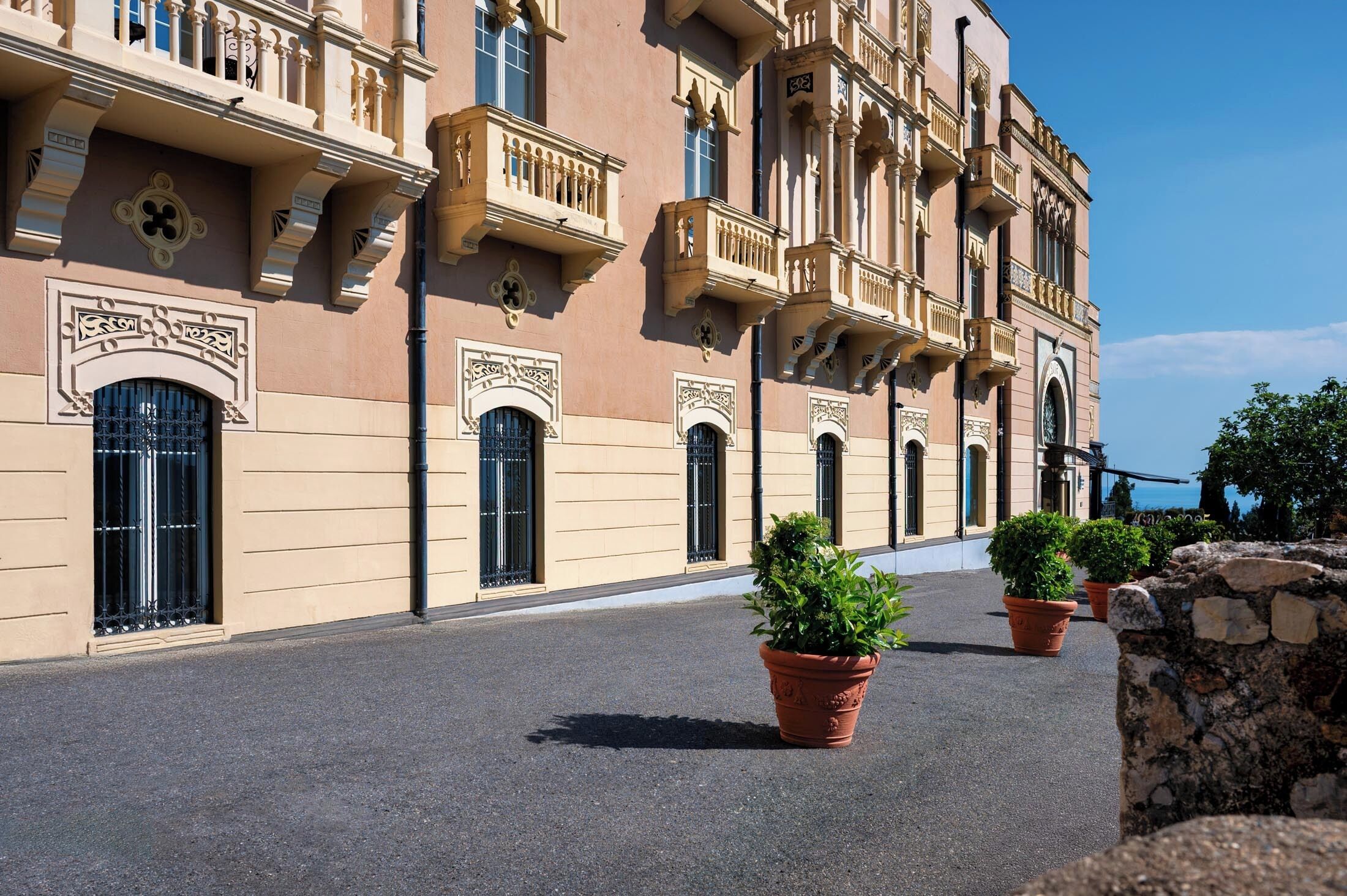 A building with ornate balconies and arched windows.