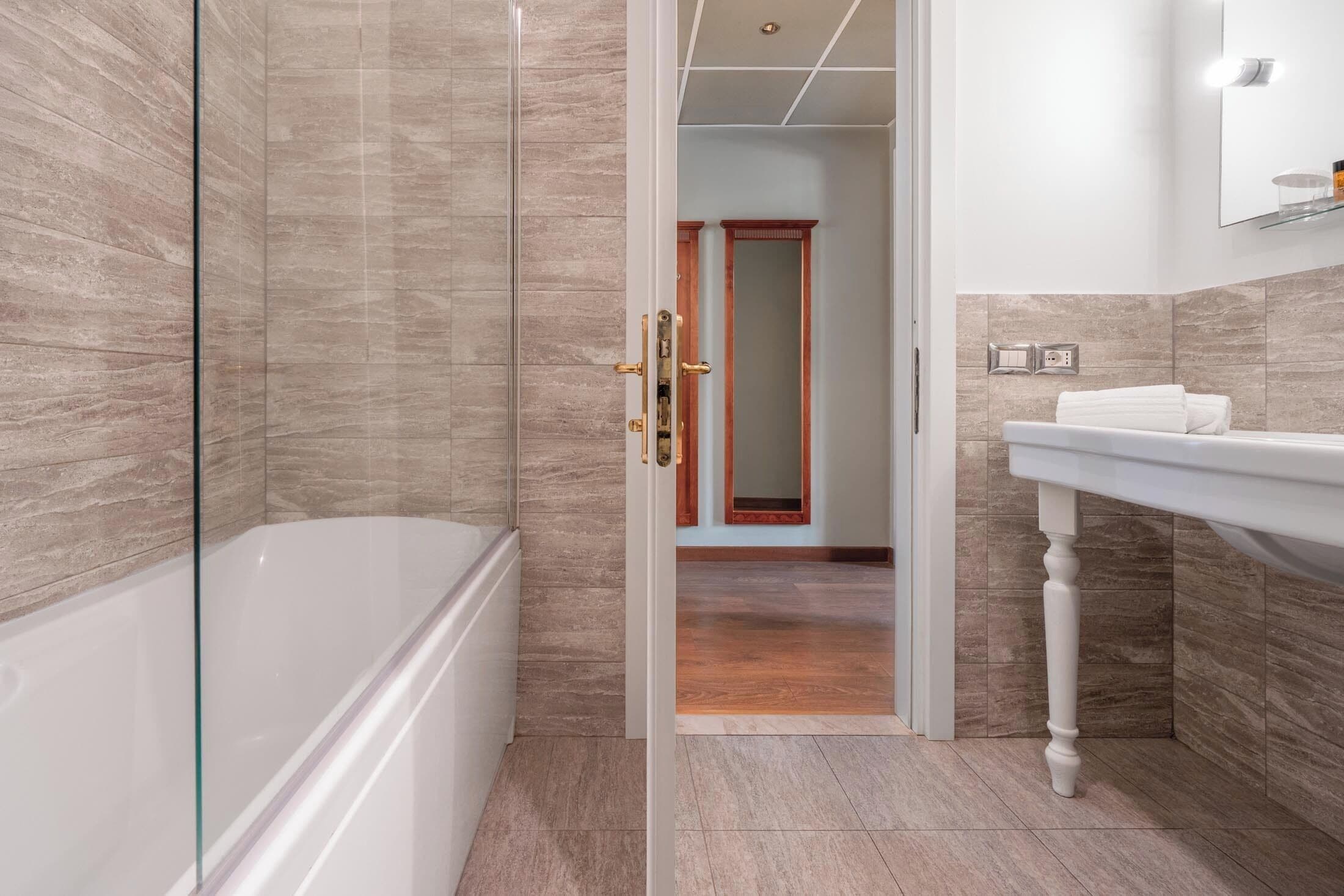 deluxe double room | bathroom | designer toiletries, hair dryer, bidet, towels