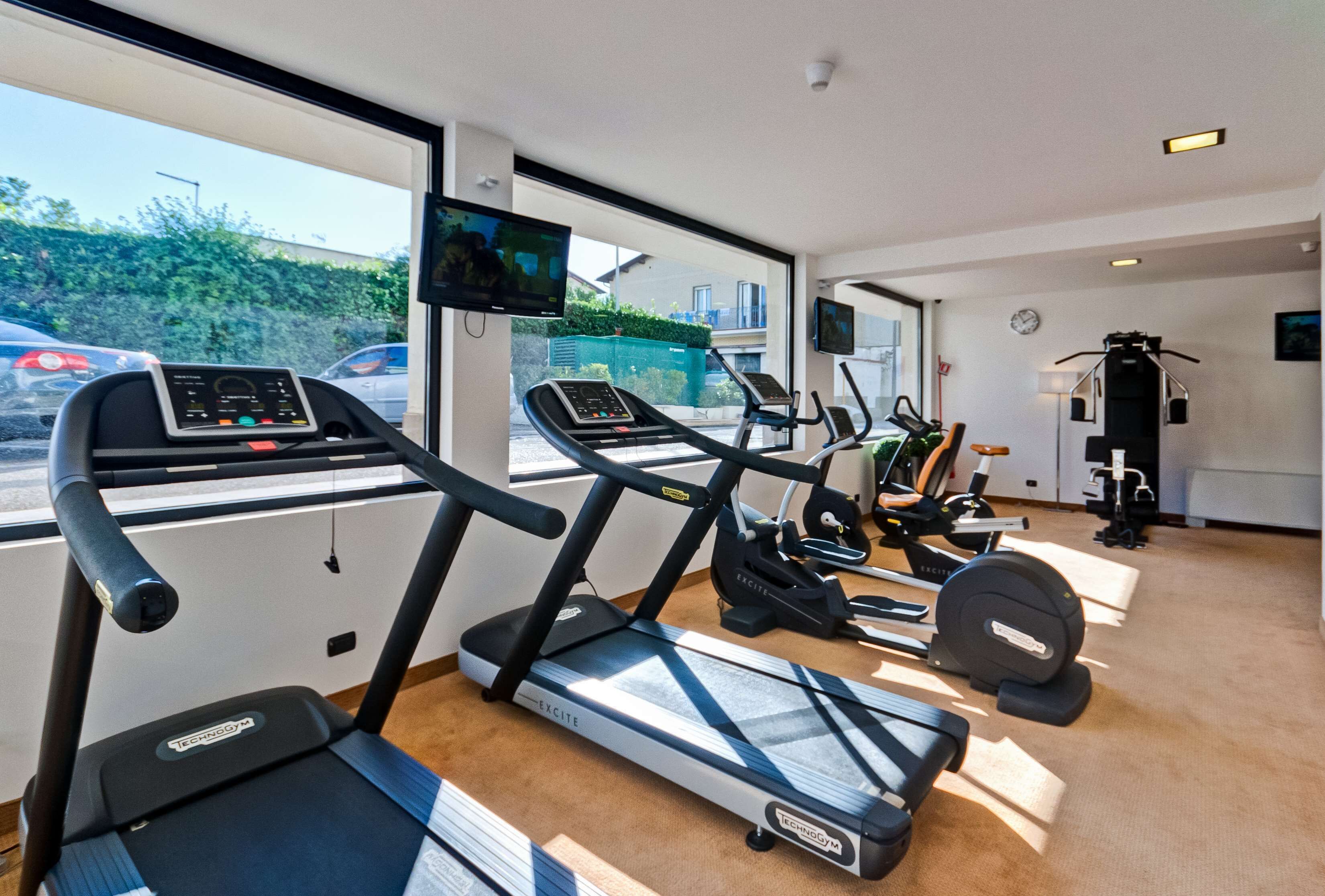 A gym with treadmills, exercise bikes, and weight machines.