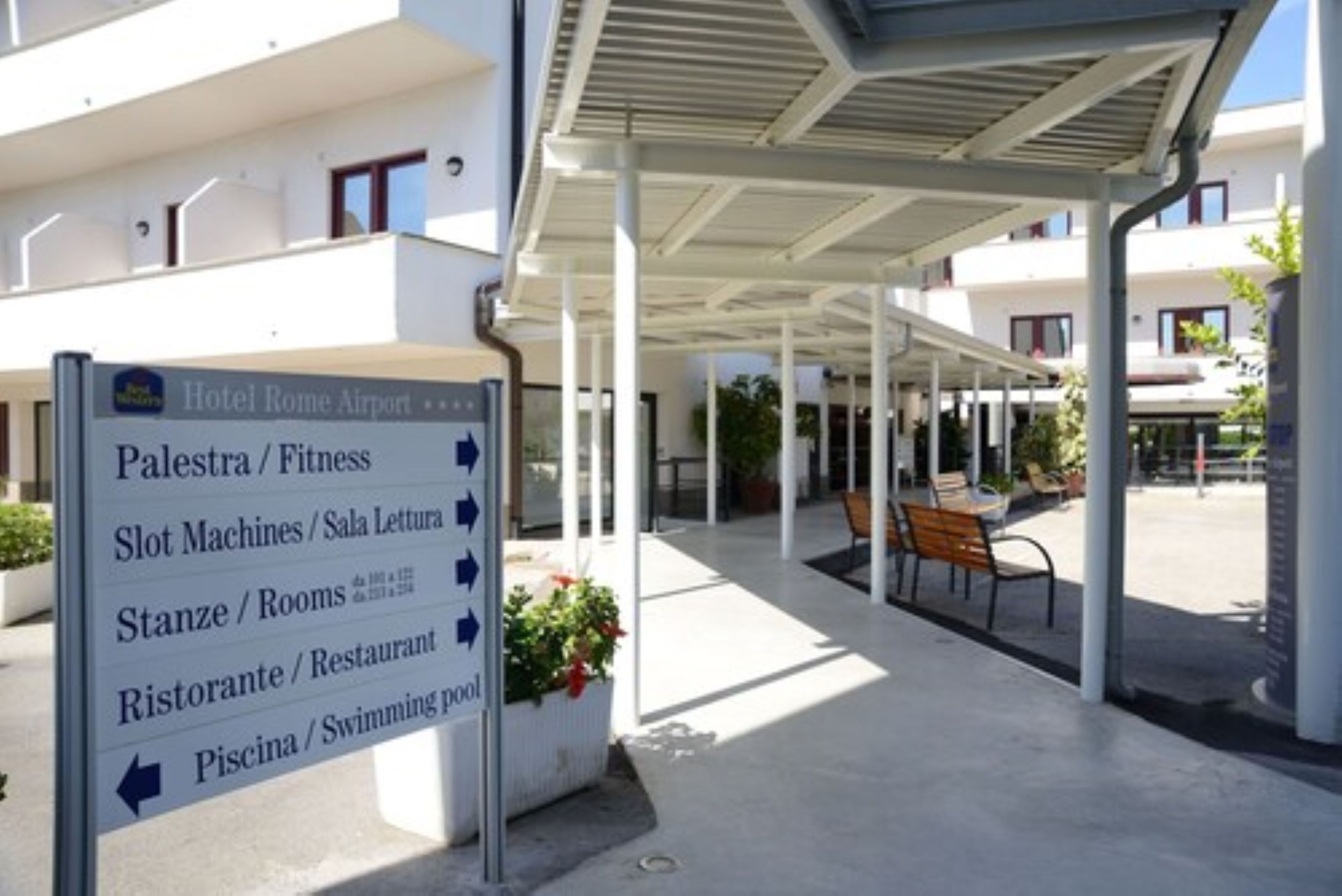 A hotel sign with directions to various amenities including fitness, slot machines, rooms, restaurant, and swimming pool.