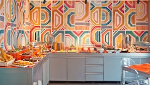 A buffet with various food items and a colorful geometric wall pattern. -  Zeus Essence Bucharest, Trademark Collection by Wyndham (Bucharest)