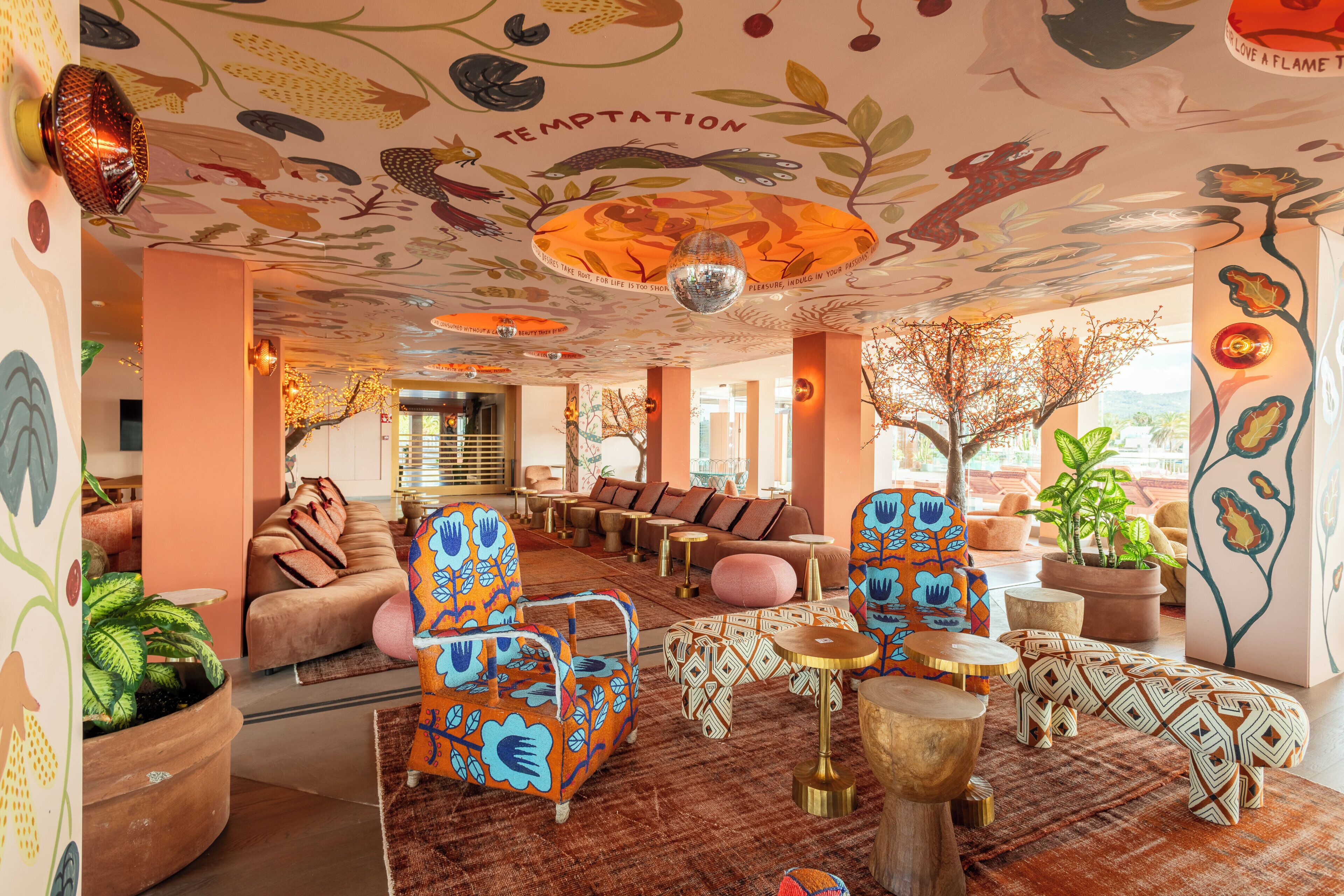 A room with a sofa, chairs, a coffee table, and a decorative ceiling.