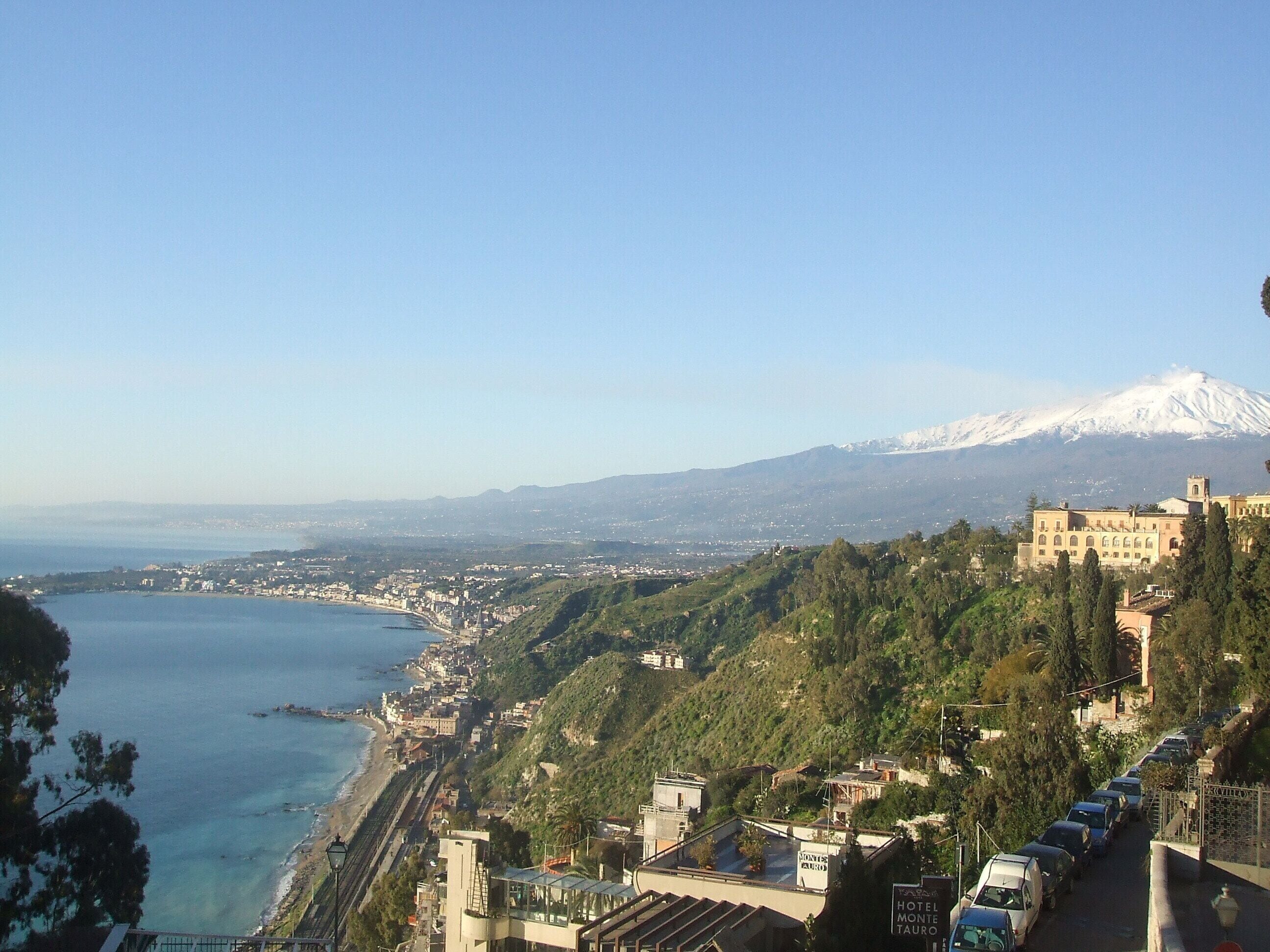A coastal town with a view of a mountain.