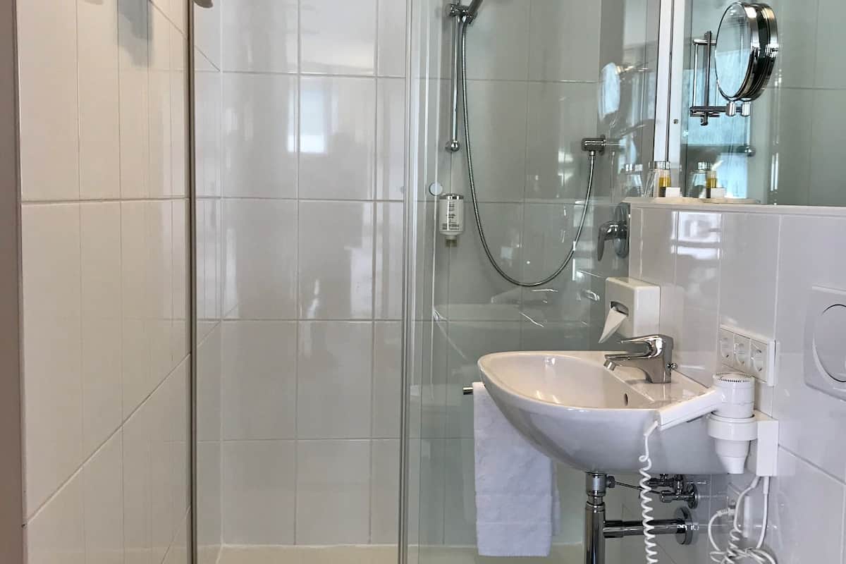 shower, hair dryer, bathrobes, slippers