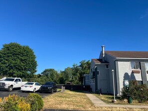 A residential area with a house, parked cars, and a clear blue sky. - Quality Inn Plainfield I-395 (Plainfield)