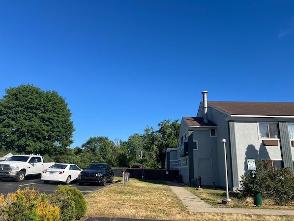 A residential area with a house, parked cars, and a clear blue sky. - Quality Inn Plainfield I-395 (Plainfield)