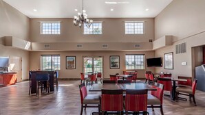 A spacious dining area with high ceilings, large windows, and modern furnishings. - Comfort Suites Delavan - Lake Geneva Area (Delavan)